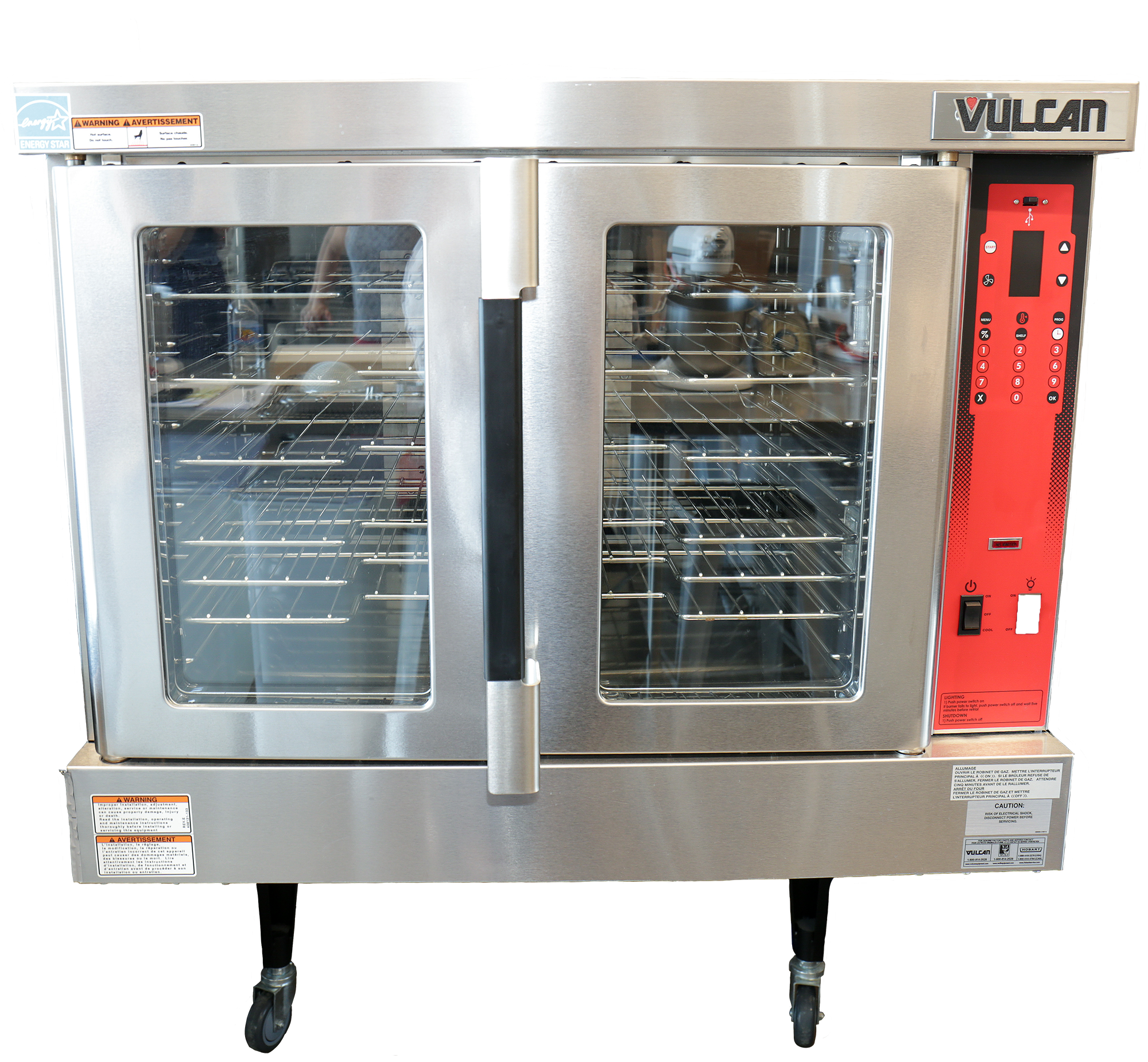 Square in shape and stainless-steel. Two doors with glass panels that make up the bulk of them. The left side has a red panel that hold the on and off switch, fan control and temperature dial.