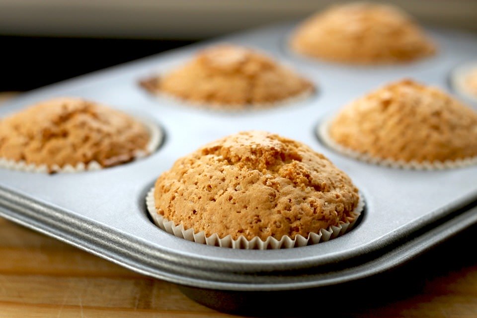 Baked muffins inside of their muffin pan.