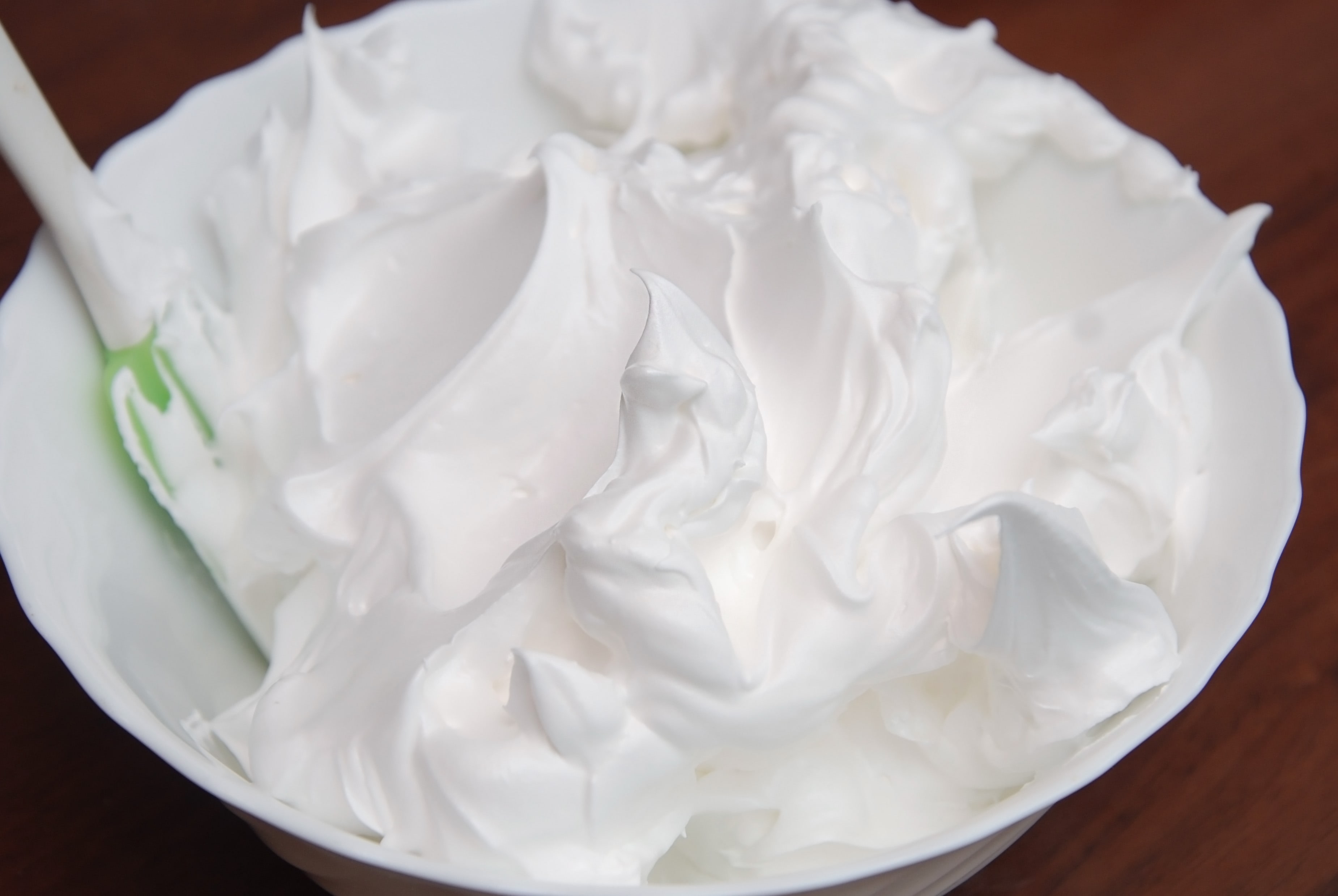 Rich and Creamy, White Whipped Meringue Cream in a large Mixing Plate.