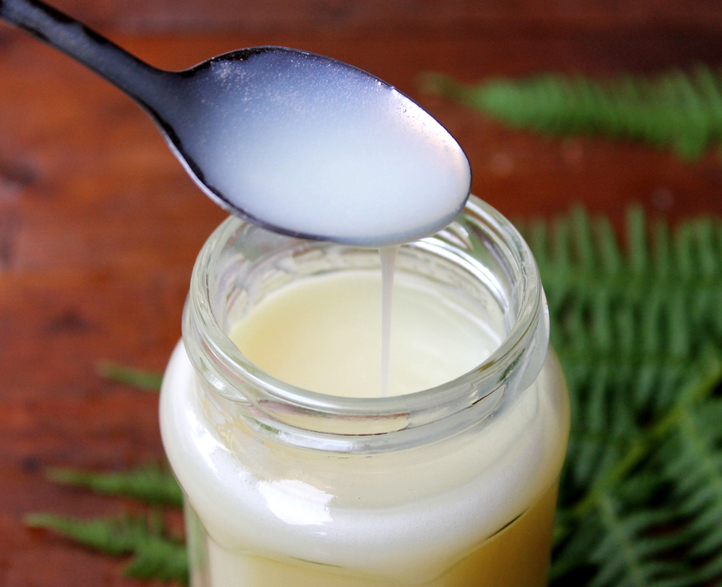 Evaporated Milk in a jar with metal spoon.