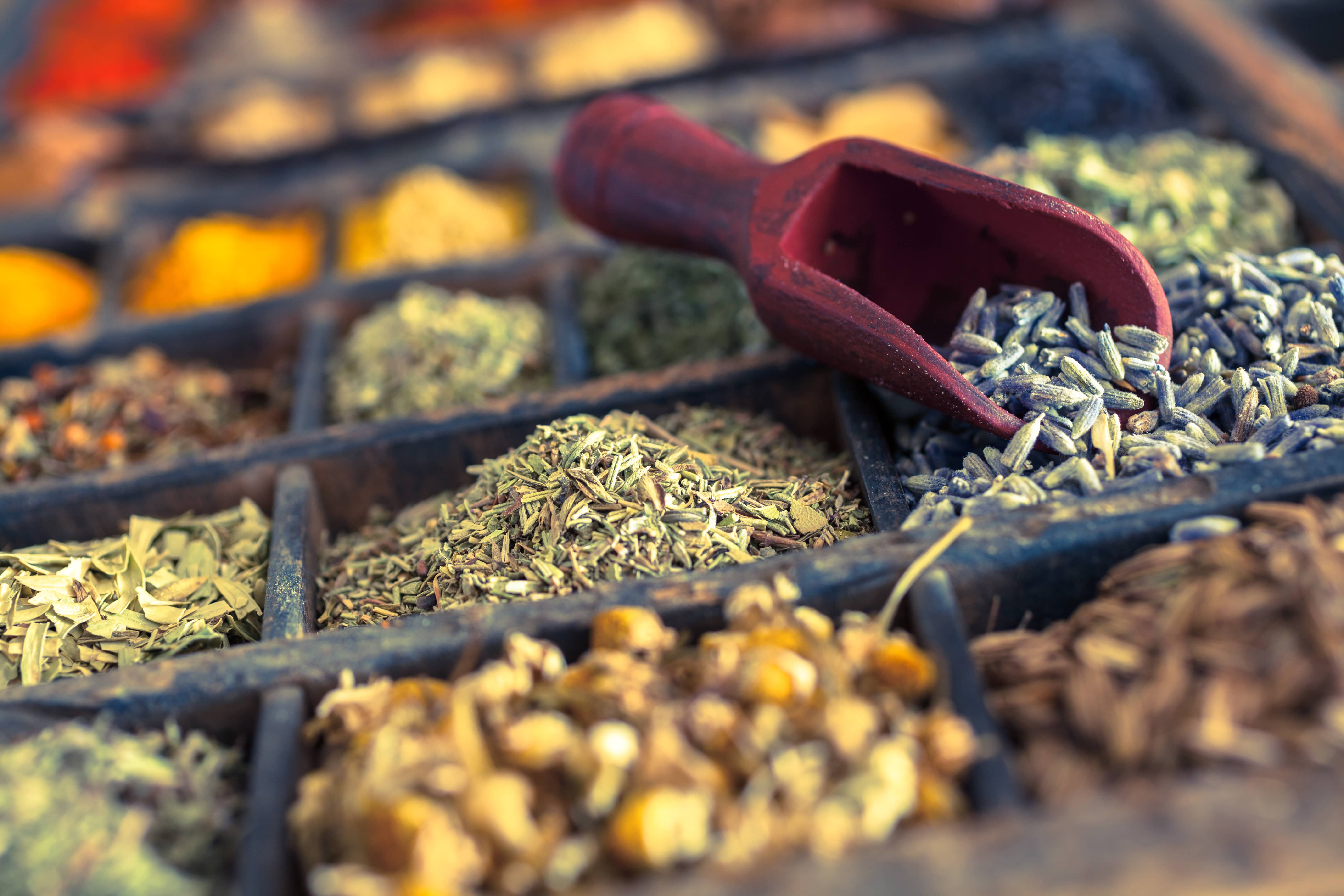 Close-up of different spices and herbs including lavender and chamomile. 