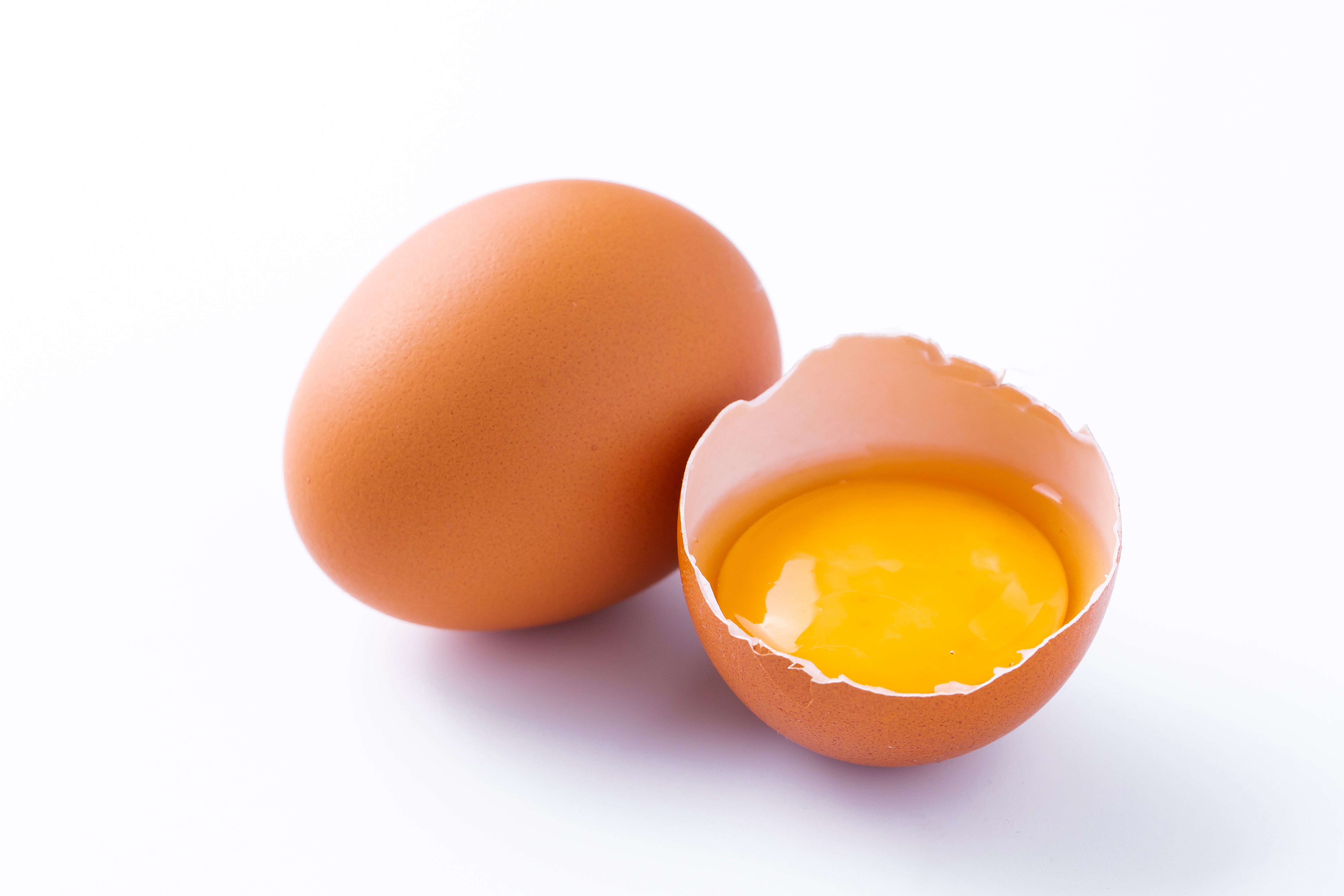 Cracked chicken egg isolated on white background.