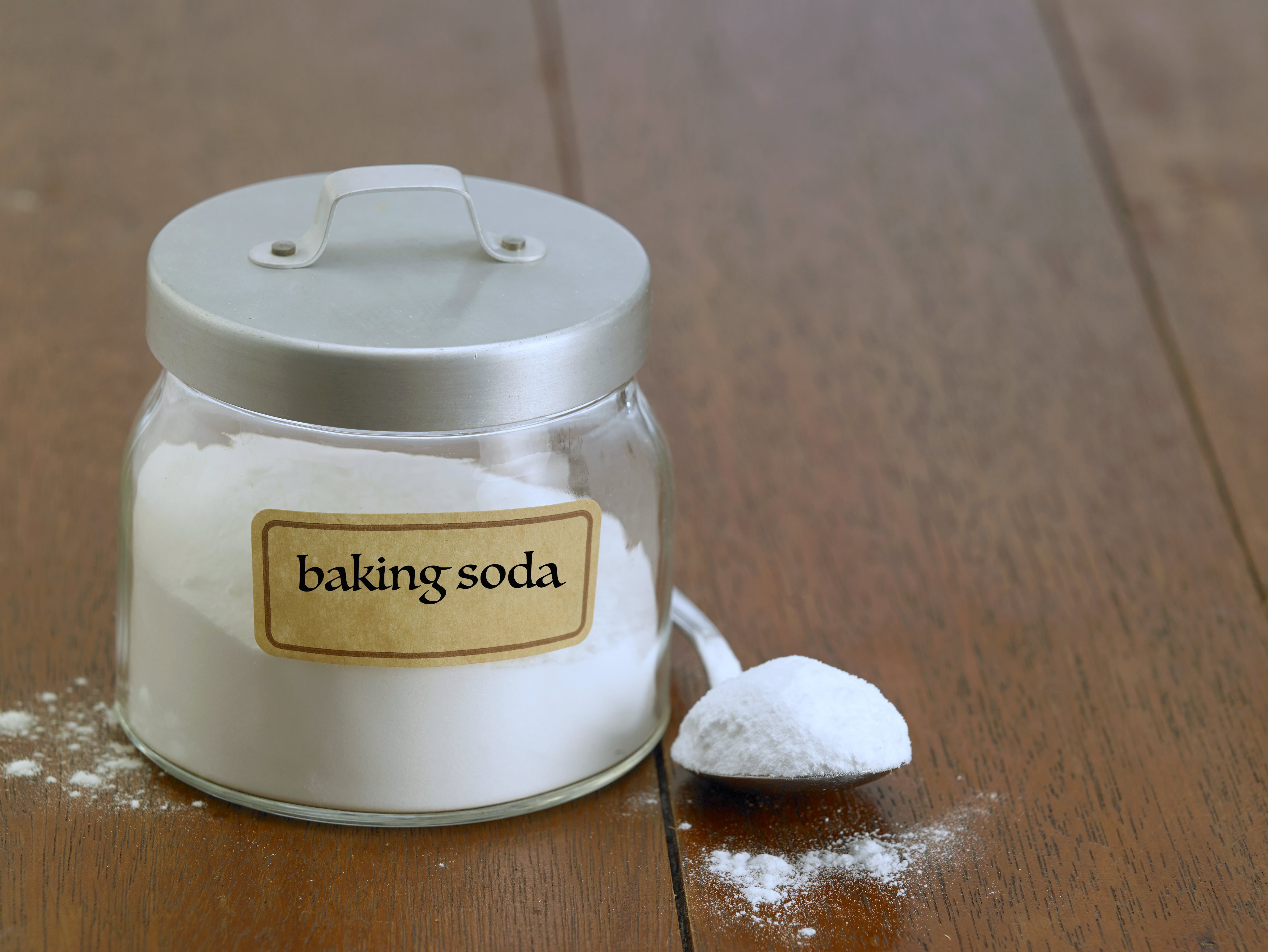 Baking soda in a jar on the wooden table top