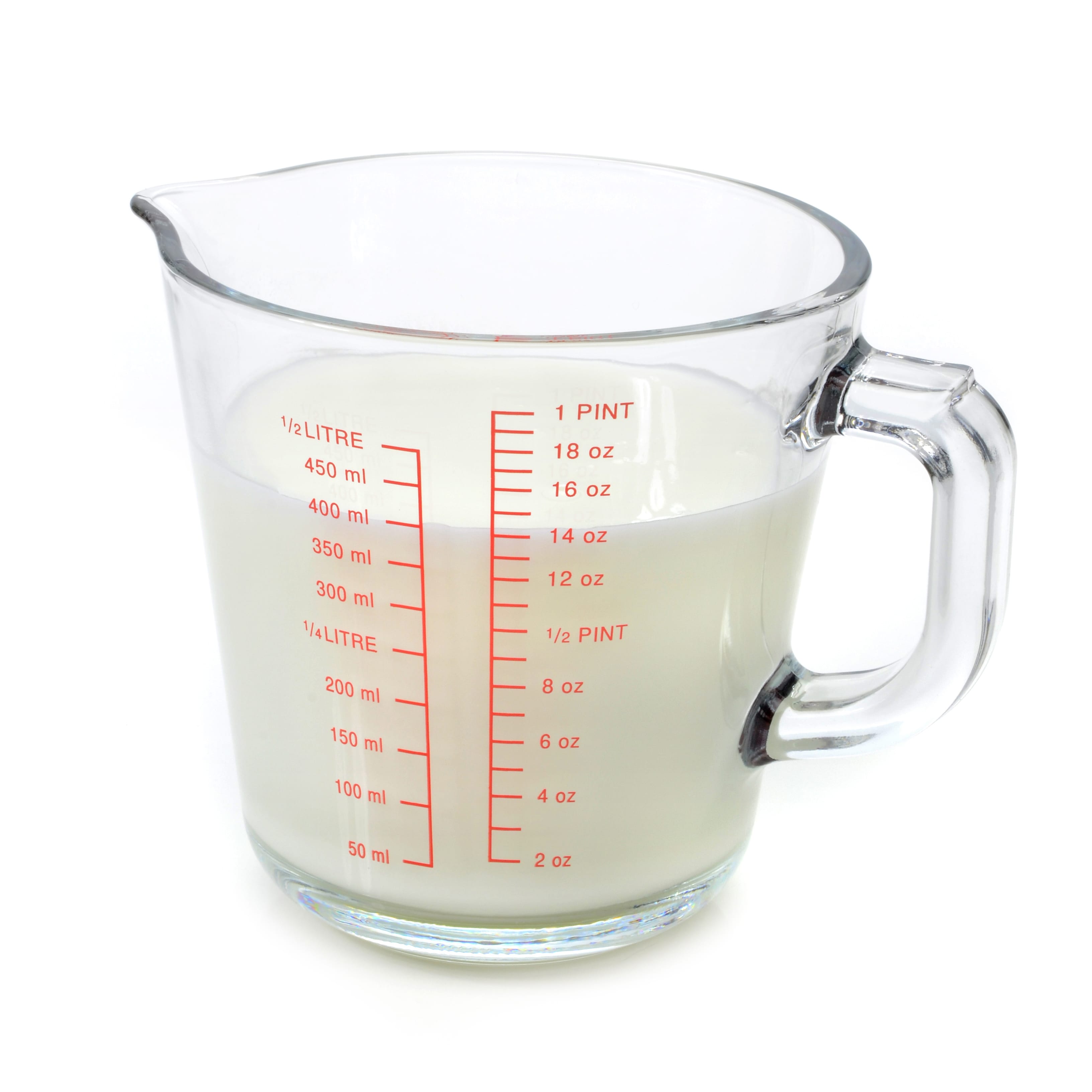 Milk in measuring cup on white background.